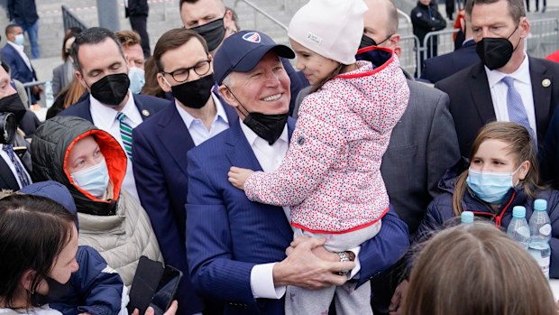 President Joe Biden meets with Ukrainian refugees during a visit to PGE Narodowy Stadium, Saturday, in Warsaw. 