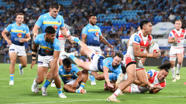 Tyrell Sloan breaks away to score a try during the round one NRL match between the Gold Coast Titans and the St George Illawarra Dragons.