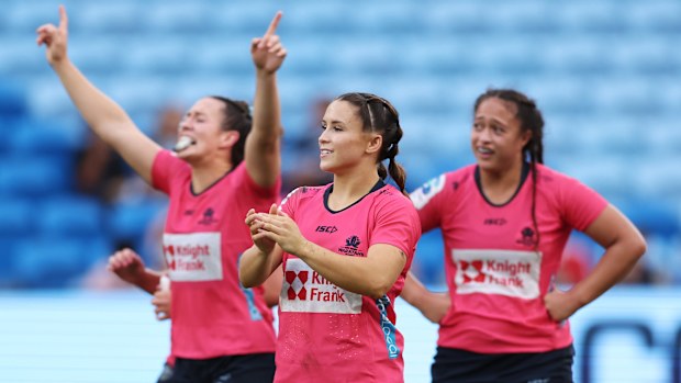 Waratahs players celebrate victory.