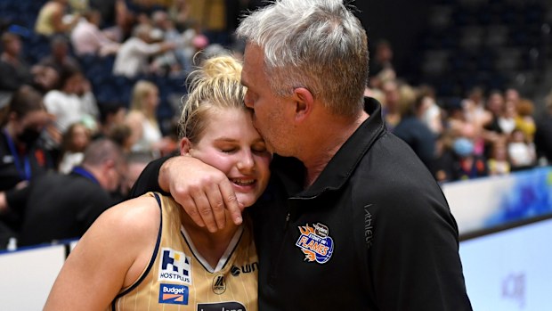 Shyla Heal of the Flames is embraced by her father and head coach, Shane Heal. 