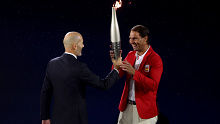 PARIS, FRANCE - JULY 26: Zinedine Zidane, former French football player and manager, hands the Olympic Torch to Spanish tennis player Rafael Nadal during the opening ceremony of the Olympic Games Paris 2024 on July 26, 2024 in Paris, France. (Photo by Matthew Stockman/Getty Images)