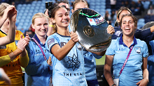 Indiana Dos Santos holds aloft the Premier's Plate after the round 20 A-League Women's match between Sydney FC and the Newcastle Jets.