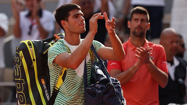 Carlos Alcaraz of Spain applauds the crowd after defeat to Novak Djokovic of Serbia.