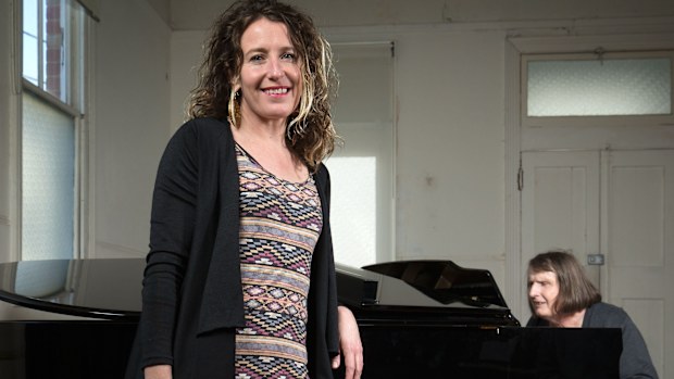 Director Jodee Mundy poses for a photo as deafblind performer Michelle Stevens plays piano on August 16, 2016 in Melbourne, Australia. Her current show 'Imagined Touch' features actors who are deaf and blind.
