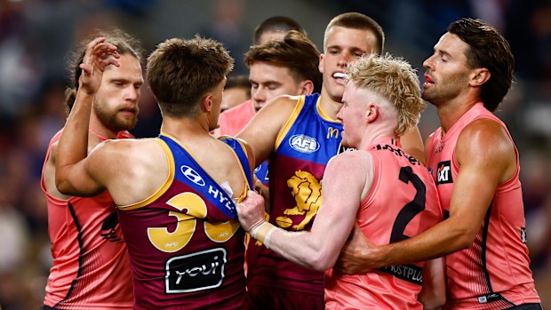 Lions and Suns players scuffle in the 2025 AFL semi final match-up.