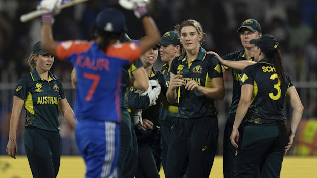Australia's players celebrate the wicket of India's Shreyanka Patil.