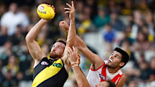 Noah Balta of the Tigers and Lewis Melican of the Swans contest the ball.