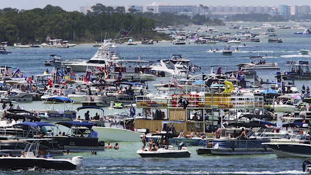 Boaters crowd an area known as "Crab Island" in the shallow waters near Destin,  Florida