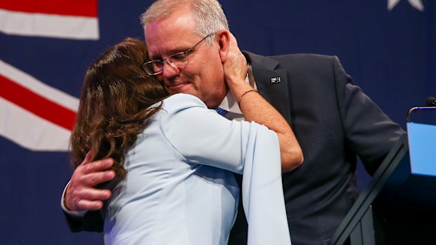 Australian Prime Minister Scott Morrison is embraced by his wife Jenny during his address to a Liberal Party function in Sydney, Australia, Saturday, May 21, 2022.  