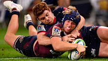 Hamish Stewart of the Reds scores a try against the Rebels.