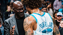 Michael Jordan shakes hands with Kelly Oubre Jr. #12 of the Charlotte Hornets after their game against the Orlando Magic at Spectrum Center on March 03, 2023 in Charlotte, North Carolina.