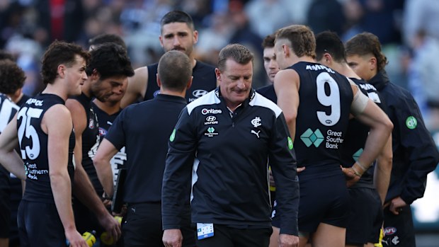 Michael Voss, coach of Carlton walks from the the 3/4 time huddle  during the round 15 AFL match between Carlton and North Melbourne.