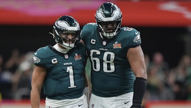 Philadelphia Eagles quarterback Jalen Hurts (1) is hugged by offensive tackle Jordan Mailata (68) after throwing a touchdown pass to wide receiver DeVonta Smith (6) during the second half of the NFL Super Bowl 59 football game, Sunday, Feb. 9, 2025, in New Orleans. (AP Photo/Matt Slocum)