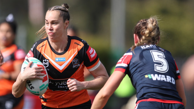 Kezie Apps of the Wests Tigers runs with the ball.