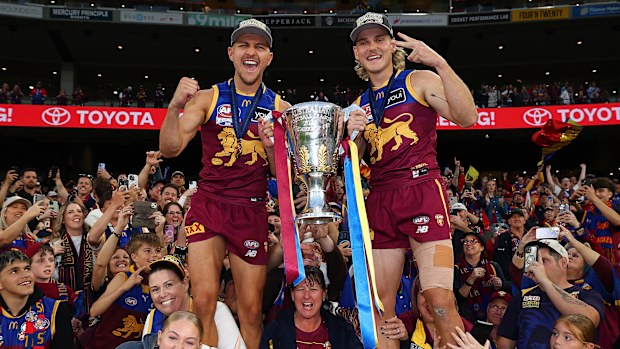 MELBOURNE, AUSTRALIA - SEPTEMBER 27: Kai Lohmann and Will Ashcroft of the Lions celebrates with the trophy after winning the AFL Grand Final match between Geelong Cats and Brisbane Lions at Melbourne Cricket Ground on September 27, 2025 in Melbourne, Australia. (Photo by Daniel Pockett/AFL Photos/via Getty Images)