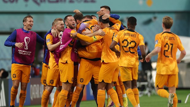 Daley Blind of Netherlands celebrates with teammates after scoring the team's second goal during the FIFA World Cup Qatar 2022 Round of 16 match between Netherlands and USA at Khalifa International Stadium on December 03, 2022 in Doha, Qatar. (Photo by Patrick Smith - FIFA/FIFA via Getty Images)