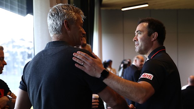 Brad Scott greets assistant coach Blake Caracella.