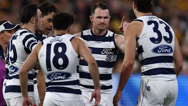 Patrick Dangerfield celebrates with teammates after kicking a goal.