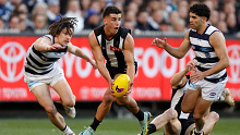Nick Daicos of the Magpies is chased by Gryan Miers of the Cats during the 2022 AFL First Qualifying Final.
