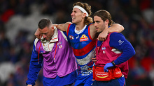 Aaron Naughton reacts to a knee injury during the Bulldogs' round 11 AFL match with the Swans.