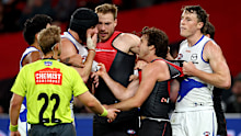 MELBOURNE, AUSTRALIA - MARCH 28: Tristan Xerri of the Kangaroos wipes blood on the face of Andrew McGrath of the Bombers during the round three AFL match between Essendon Bombers and North Melbourne Kangaroos at Marvel Stadium, on March 28, 2026, in Melbourne, Australia. (Photo by Josh Chadwick/Getty Images)