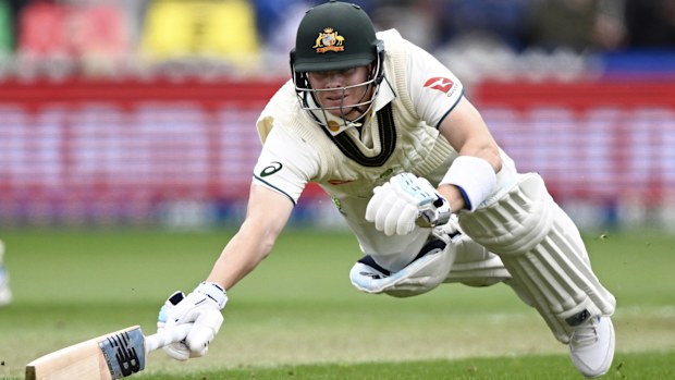 Australia's Steve Smith dives to make his ground while batting against New Zealand on the first day of their cricket test match in Wellington,
