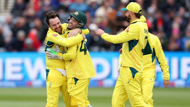 Travis Head of Australia celebrates with teammates after claiming the wicket of Brydon Carse of England.