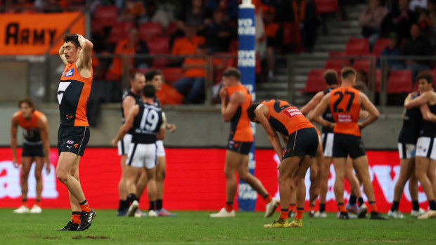 The Giants look dejected after their defeat by the Blues. 