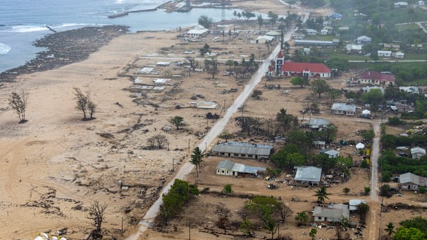 In this photo supplied by the Royal Australian Navy, an Australian Defence Force MRH-90 Taipan helicopter provides aerial reconnaissance of Eua Island in Tonga  on Feb. 21, 2022. Three months on from a devastating volcano and tsunami in Tonga, the AP checks in on how the island nation is recovering. The bill from the tsunami is estimated at some $90 million and GDP is expected to fall by more than 7% this year. The cleanup has been hindered by an internet outage caused by the tsunami and the nat