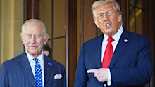 FILE - President Donald Trump gestures next to Britain's King Charles III before leaving Windsor Castle, Windsor, England, Sept. 18, 2025. (AP Photo/Evan Vucci, file)
