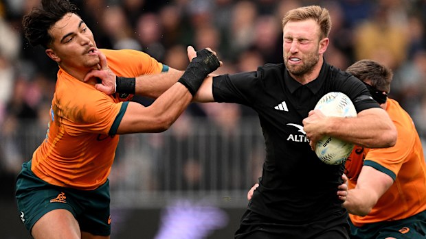 Braydon Ennor of New Zealand fends off Jordan Petaia of Australia.