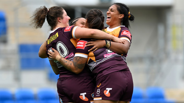 Broncos players celebrate their last-minute victory over the Sharks in round 8.