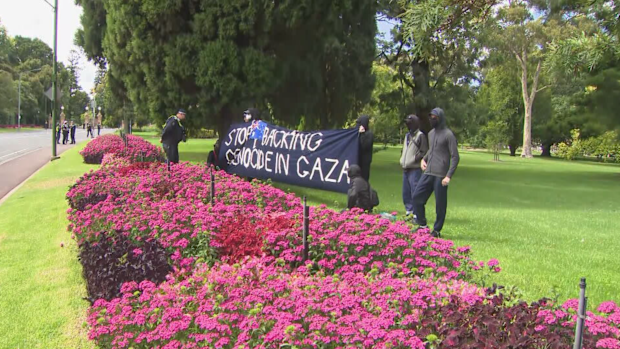 Police quickly moved on a small protest outside Government House during the President's visit.