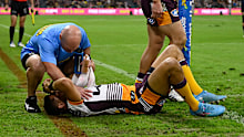 Te Maire Martin of the Broncos receives treatment after being injured during the round 16 match against the Cowboys.