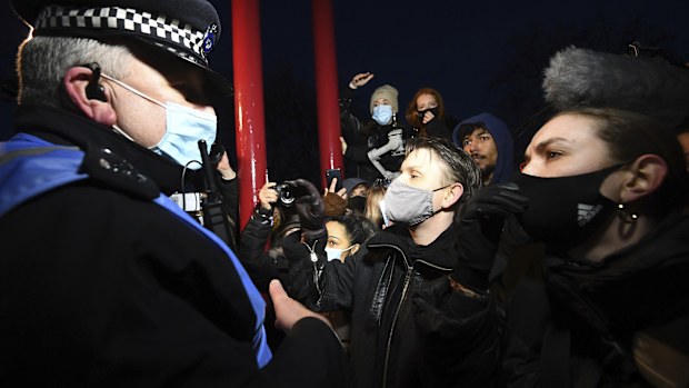 People react with police, in Clapham Common as people gather, despite the Reclaim These Streets vigil for Sarah Everard being officially cancelled.