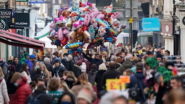 Christmas shoppers make their way along the High Street in Winchester, England as the government refused to rule out introducing further restrictions to slow the spread of the Omicron variant.