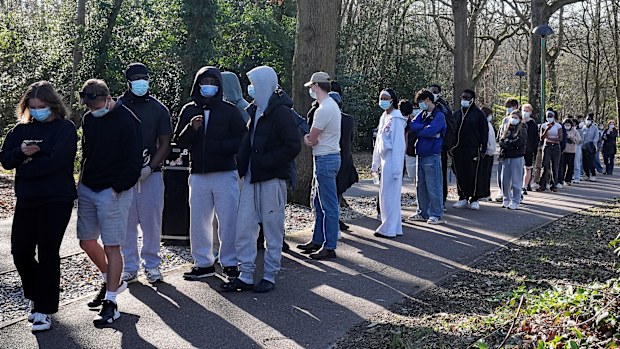 Students wait in line outside the sports hall at the University of Kent campus in Canterbury, England, Wednesday, March 18, 2026, where the rollout of a meningitis B vaccine to about 5,000 students has begun.  