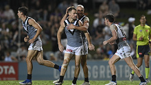 The Power's Robbie Gray celebrates with teammates after kicking a goal.