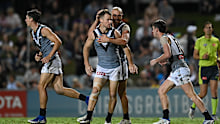 The Power's Robbie Gray celebrates with teammates after kicking a goal.