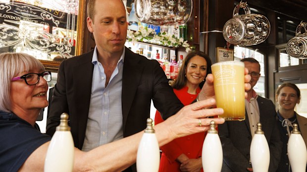 Britain's Prince William pulls the first pint of Kingmaker, a new brew celebrating the coronation of King Charles III, as he and the Princess of Wales visit the Dog & Duck pub in London, Thursday, May 4, 2023.