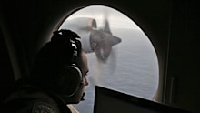 Flight officer Rayan Gharazeddine scans the water in the southern Indian Ocean off Australia from a Royal Australian Air Force AP-3C Orion during a search for the missing Malaysia Airlines Flight MH370, March 22, 2014