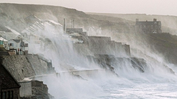 Waves hits Porthleven on the Cornish coast, Britain, as Storm Eunice makes landfall Friday, Feb. 18, 2022. Millions of Britons are being urged to cancel travel plans and stay indoors Friday amid fears of high winds and flying debris as the second major storm this week prompted a rare red weather warning across southern England. (Matt Keeble/PA via AP)