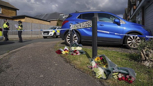 Grieving neighbours have begun laying flowers and handwritten notes at a makeshift memorial on Ashlyn Close