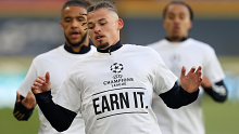 Kalvin Phillips of Leeds United warms up while wearing a protest t-shirt reading "Champions League, Earn it."
