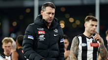 Craig McRae, Senior Coach of the Magpies is dejected during their loss to Geelong.