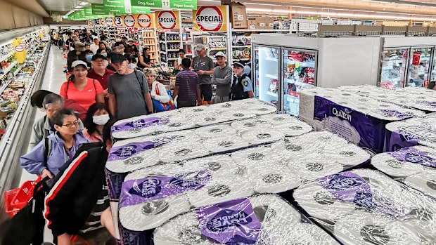 People awaiting their turn to purchase toilet paper, paper towel and pasta at Coles in Epping, Sydney.