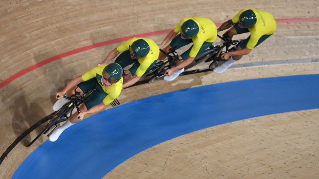 Australia's team pursuit track cyclists accelerate.