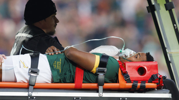 Springboks debutant Grant Williams is carted off after taking a hip to the head. 