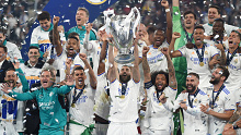 Karim Benzema of Real Madrid lifts UEFA Champions League Trophy following his team's victory.