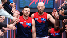 Steven May and Max Gawn lead the Demons players out.